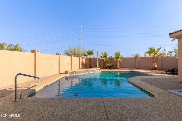 view of pool featuring pool water feature and a patio