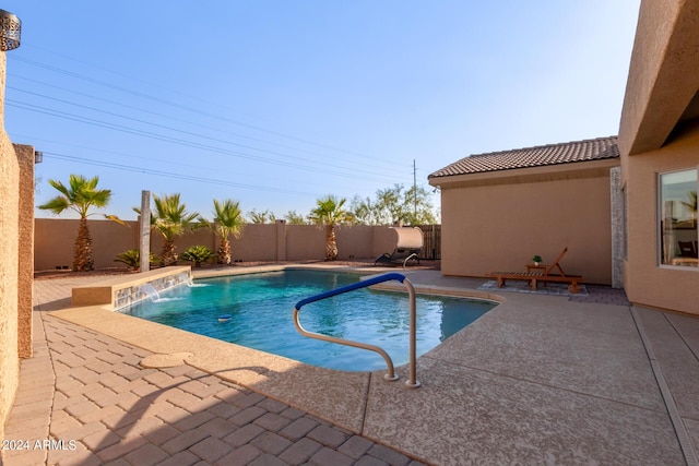 view of pool featuring pool water feature and a patio area