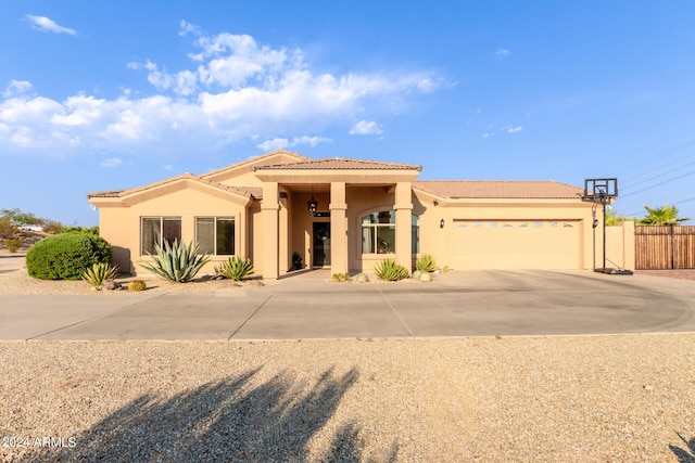 mediterranean / spanish-style home with a garage