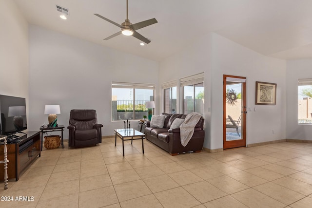 living room featuring light tile patterned flooring, a towering ceiling, and ceiling fan