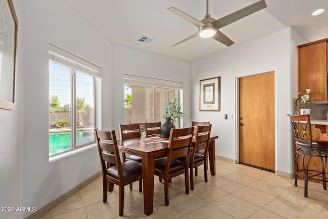 tiled dining area with ceiling fan