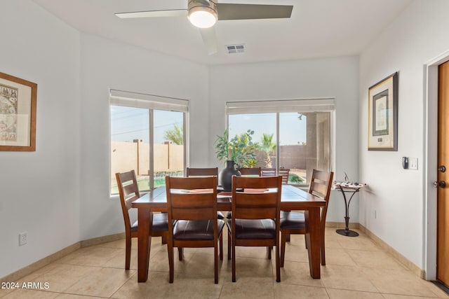 tiled dining area with a wealth of natural light and ceiling fan