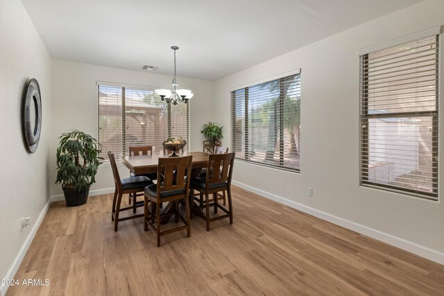 dining room with a notable chandelier and light hardwood / wood-style floors