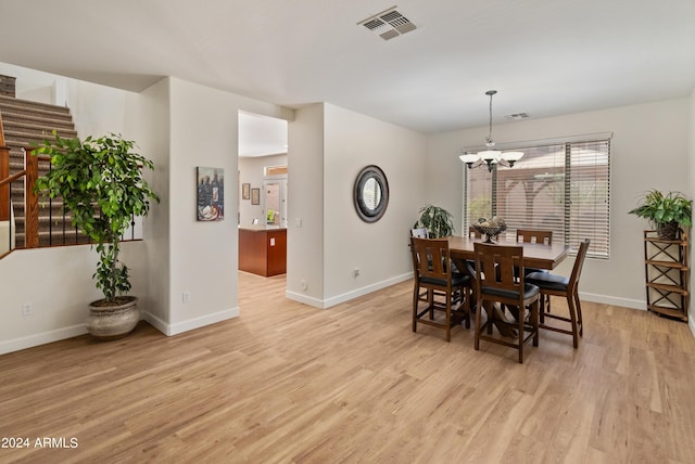 dining room featuring a chandelier and light hardwood / wood-style flooring