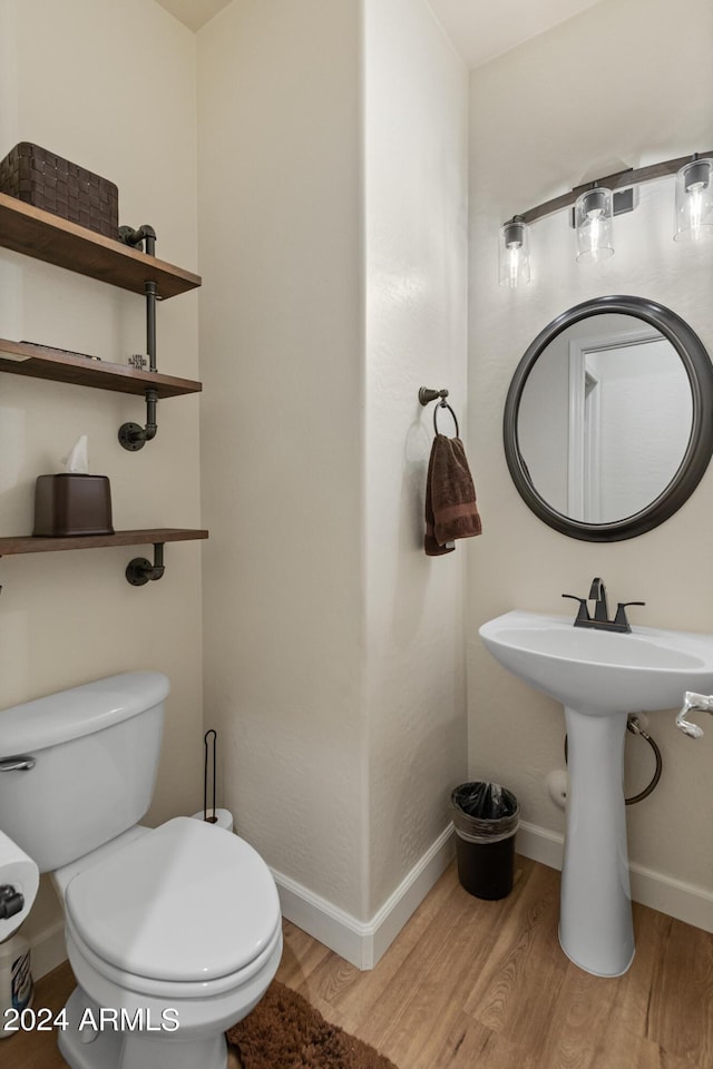 bathroom featuring wood-type flooring and toilet