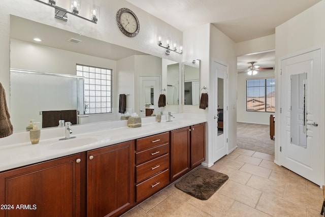 bathroom with walk in shower, ceiling fan, vanity, and tile patterned floors