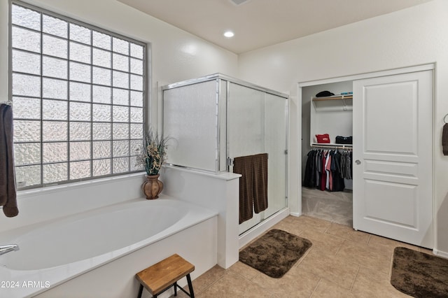 bathroom featuring tile patterned floors and shower with separate bathtub