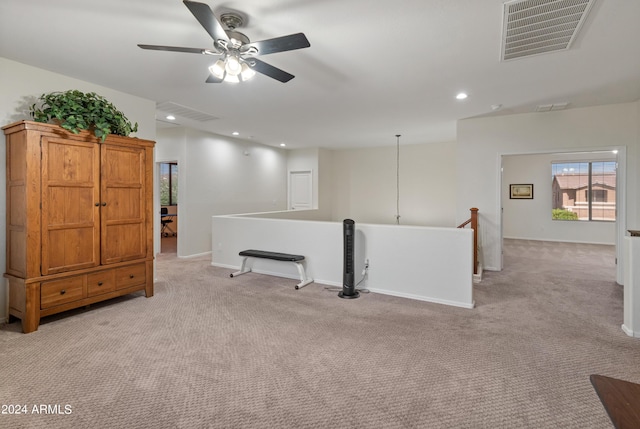 spare room featuring light colored carpet and ceiling fan