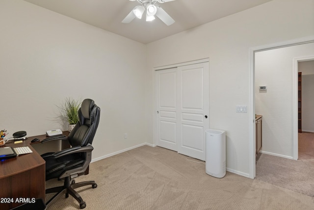 carpeted office featuring ceiling fan