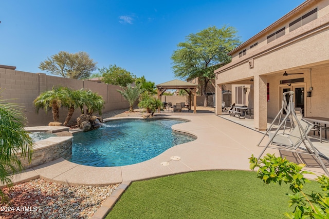 view of pool with a gazebo, a patio area, ceiling fan, and an in ground hot tub