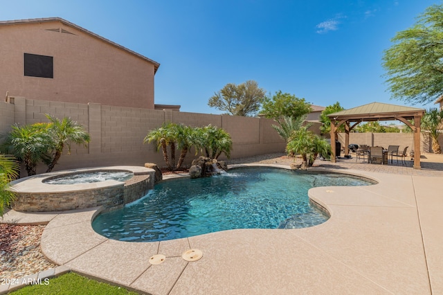 view of swimming pool with a gazebo, a patio area, pool water feature, and an in ground hot tub