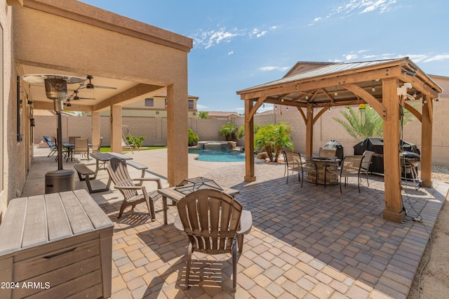 view of patio with a fenced in pool, a gazebo, and ceiling fan