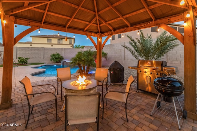 view of patio featuring a gazebo, pool water feature, a grill, and a fire pit