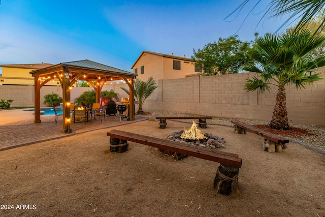 exterior space with a fire pit and a gazebo