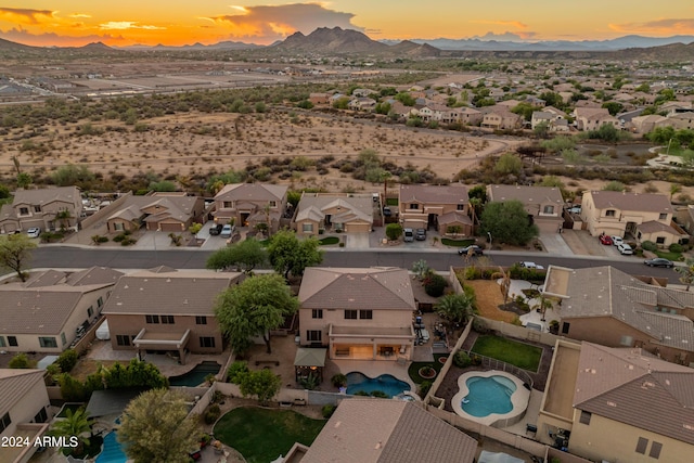 aerial view at dusk featuring a mountain view