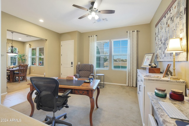 home office with a healthy amount of sunlight, ceiling fan, and light carpet