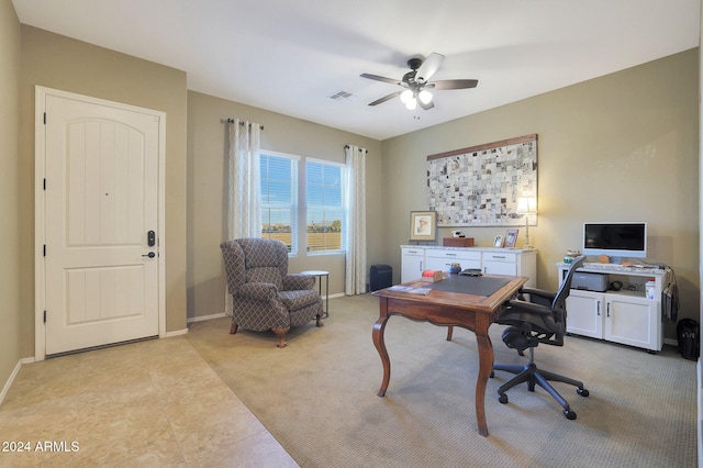 home office with ceiling fan and light carpet