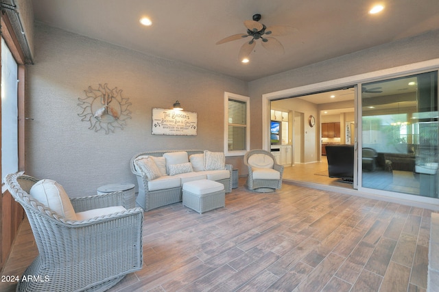 living room with hardwood / wood-style floors and ceiling fan