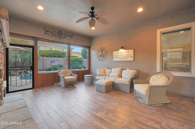 living room with wood-type flooring and ceiling fan