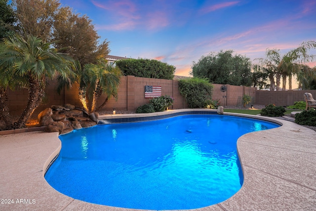 view of pool at dusk