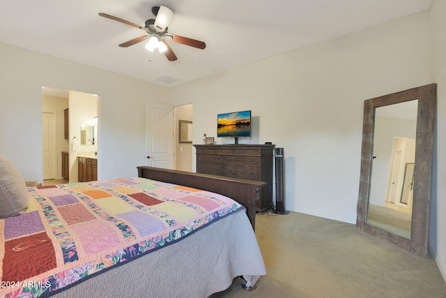 carpeted bedroom featuring ceiling fan and ensuite bathroom