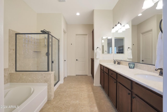 bathroom featuring independent shower and bath, tile patterned flooring, and vanity