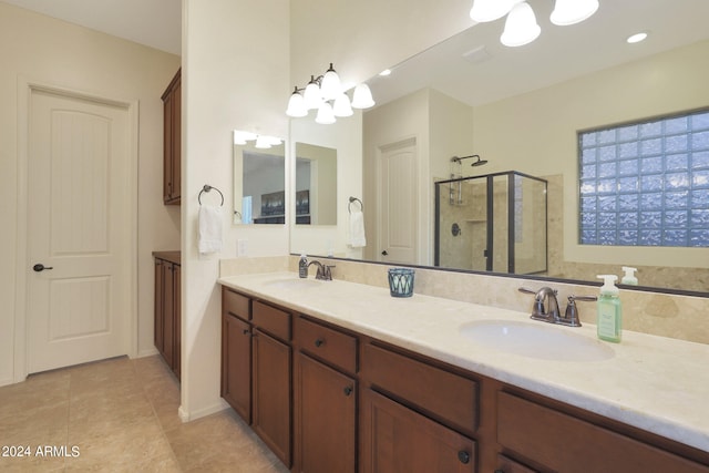 bathroom featuring walk in shower, tile patterned flooring, vanity, and a notable chandelier