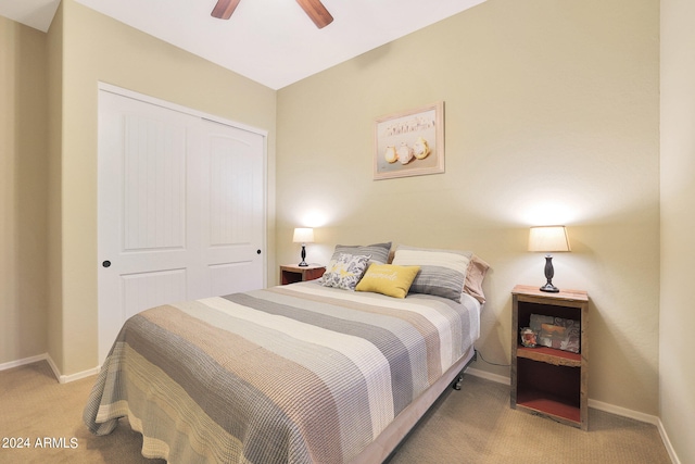 carpeted bedroom featuring ceiling fan and a closet