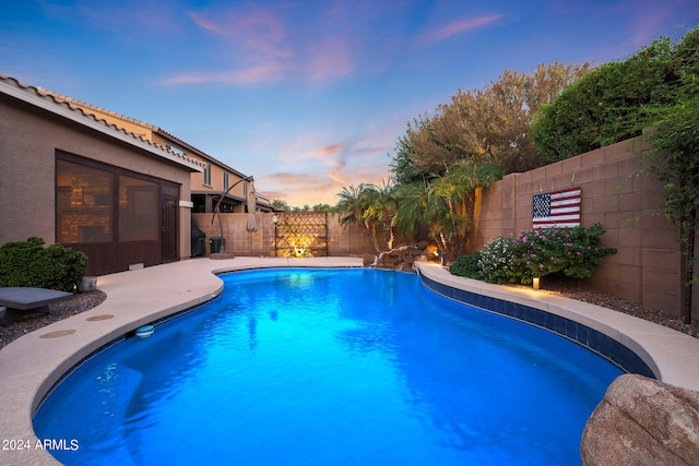 view of pool at dusk