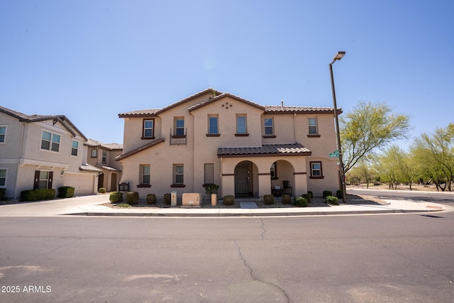 16425 W Latham St, Goodyear, AZ 85338 - view of front facade with stucco siding, concrete driveway, and a tiled roof