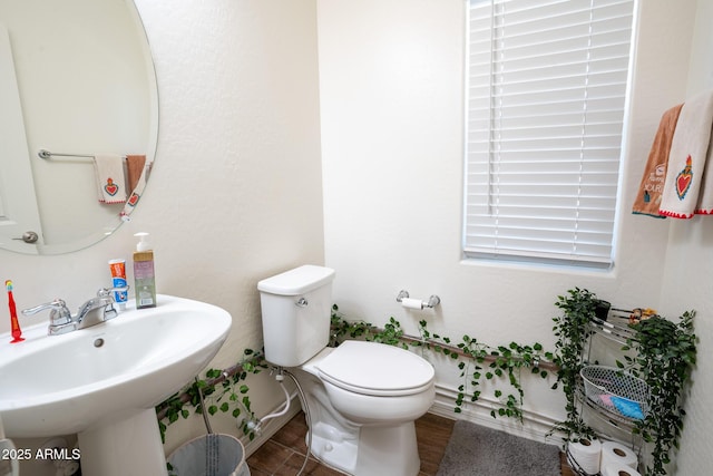 16425 W Latham St, Goodyear, AZ 85338 - bathroom featuring toilet, a sink, and wood finished floors