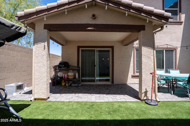 16425 W Latham St, Goodyear, AZ 85338 - rear view of house featuring a patio, fence, and stucco siding