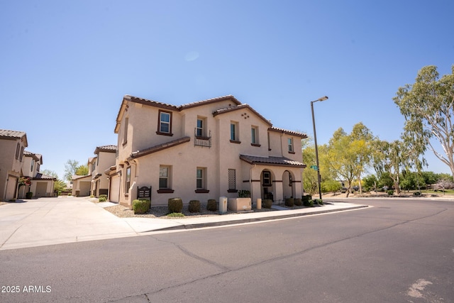 16425 W Latham St, Goodyear, AZ 85338 - view of front facade with a tile roof, stucco siding, concrete driveway, and a garage