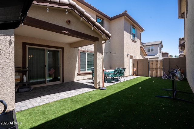 16425 W Latham St, Goodyear, AZ 85338 - rear view of property featuring stucco siding, a patio area, and a tile roof