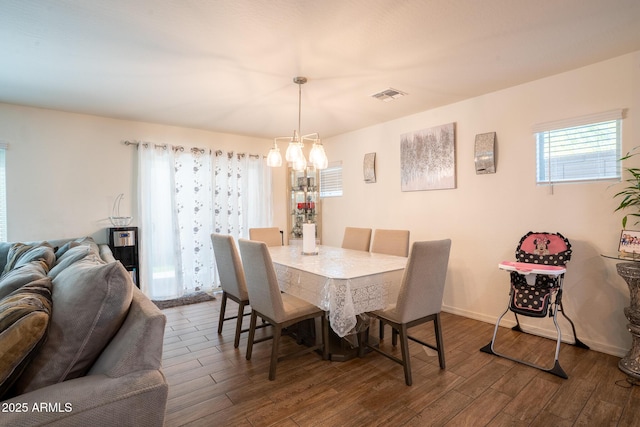 16425 W Latham St, Goodyear, AZ 85338 - dining area with a chandelier, dark wood-style floors, and baseboards