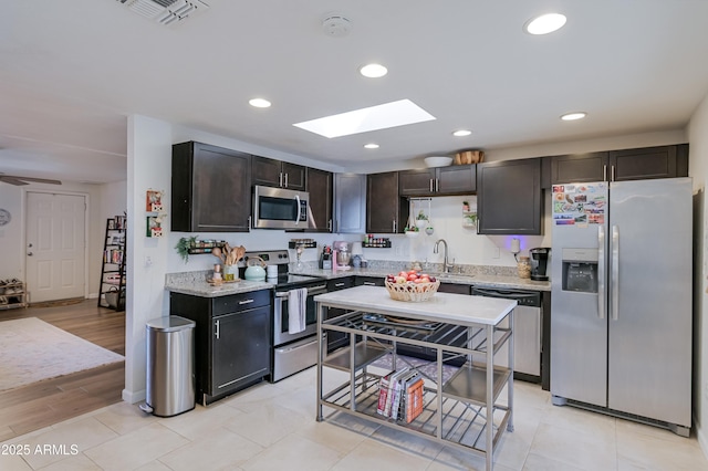 kitchen with visible vents, a sink, recessed lighting, appliances with stainless steel finishes, and a skylight