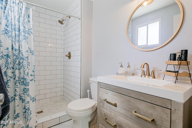 full bath featuring a stall shower, toilet, and vanity