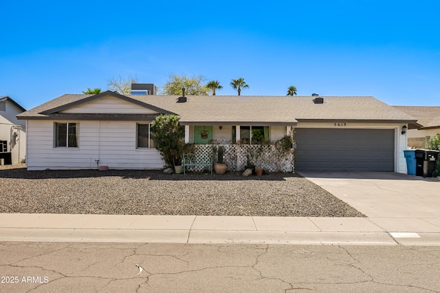 single story home featuring concrete driveway and a garage