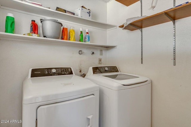 clothes washing area with separate washer and dryer