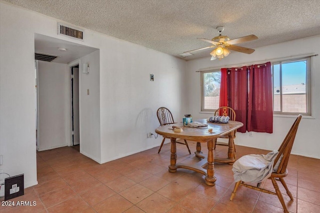 dining space featuring a wealth of natural light, light tile patterned flooring, a textured ceiling, and ceiling fan