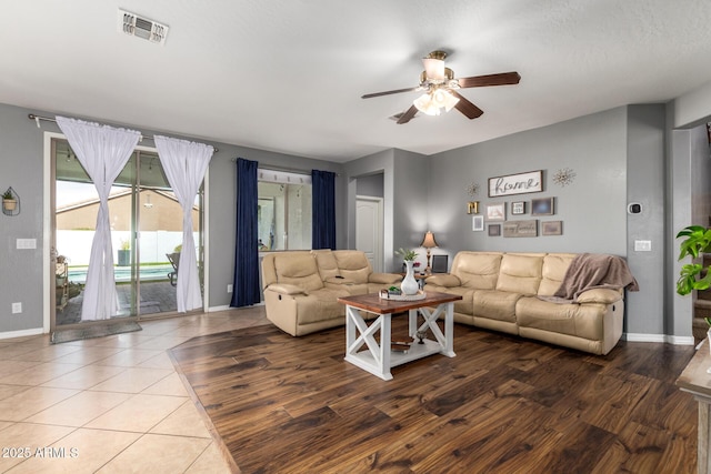 living room with wood-type flooring and ceiling fan