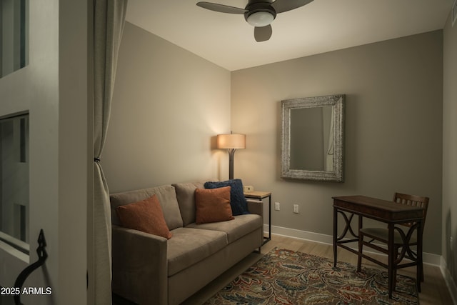 living room featuring hardwood / wood-style floors and ceiling fan