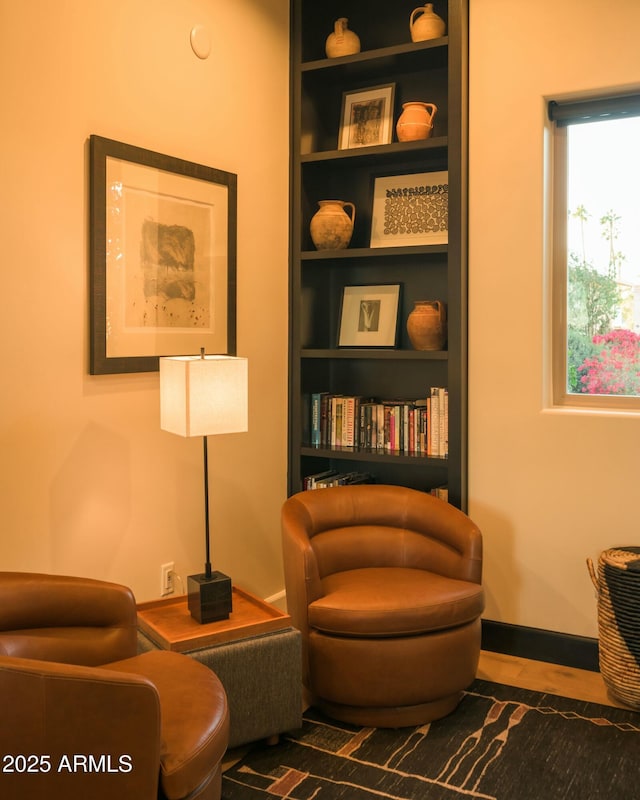 sitting room featuring built in features and baseboards