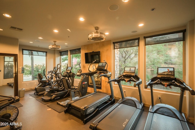 workout area with baseboards, visible vents, and recessed lighting