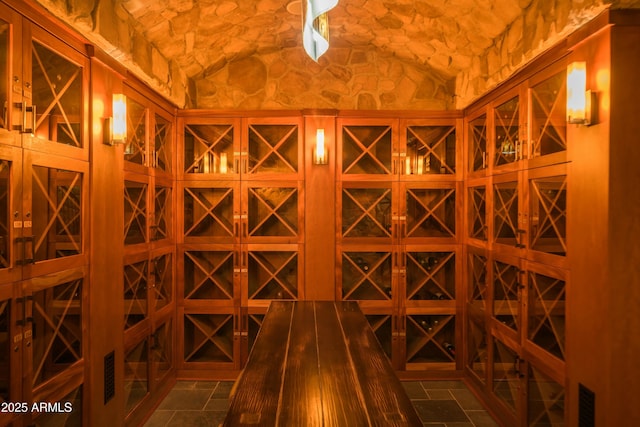 wine room with vaulted ceiling and brick ceiling