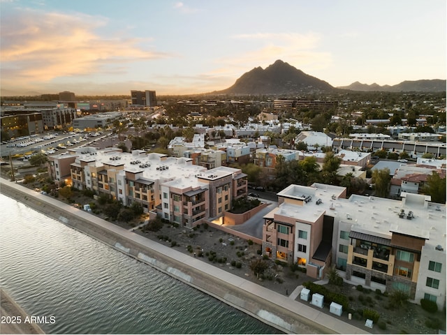 aerial view at dusk with a view of city and a water view