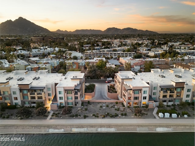 aerial view at dusk featuring a mountain view