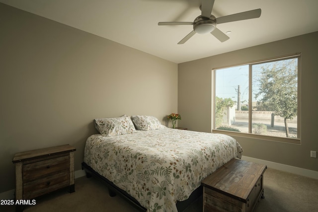 bedroom featuring dark carpet, multiple windows, and ceiling fan