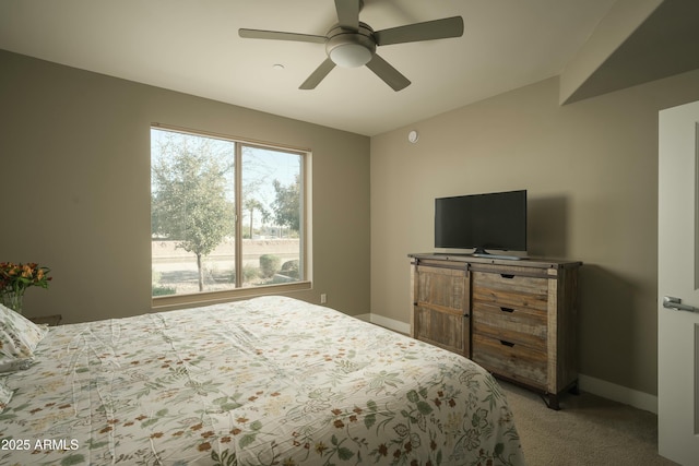 bedroom featuring light carpet, ceiling fan, and baseboards