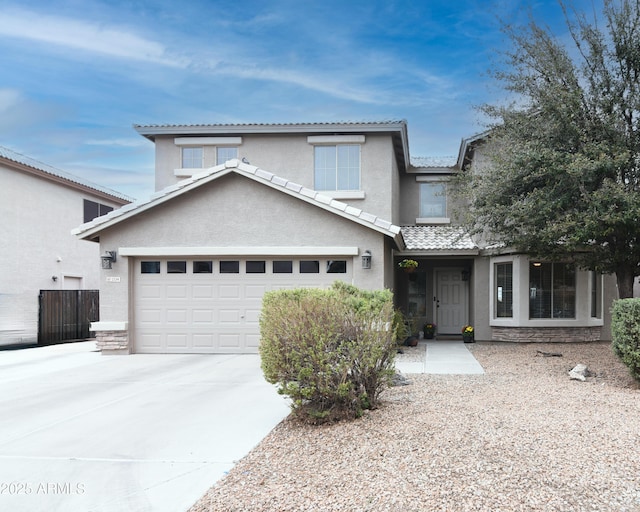 traditional-style house with stucco siding, concrete driveway, a garage, stone siding, and a tiled roof